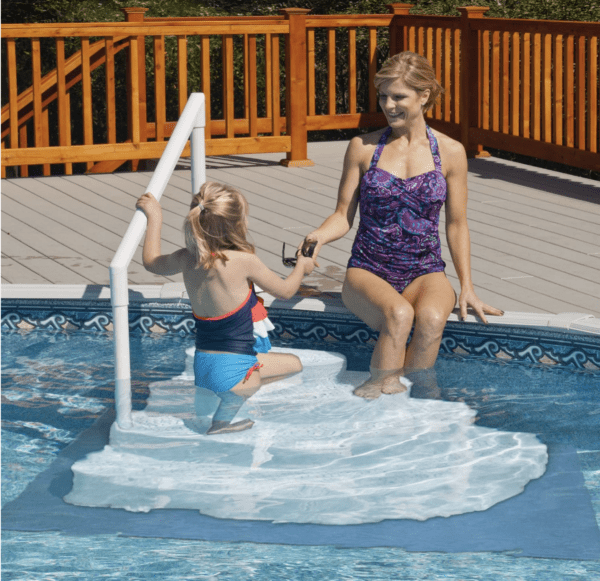 Woman and child at pool with safety steps.